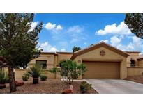 Charming single-story home featuring desert landscaping and a two-car garage at 11013 Mission Lakes Ave, Las Vegas, NV 89134
