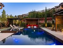 Inviting pool area features ample seating and lush landscaping with a serene ambiance at 12119 Castilla Rain Ave, Las Vegas, NV 89138