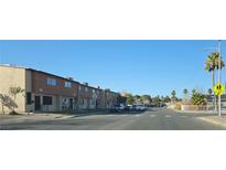 A street view of residential townhomes with blue sky and visible sidewalks and street at 2525 Donna St # L, North Las Vegas, NV 89030