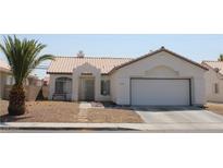 Charming single-story home with stucco exterior, desert landscaping, and attached two-car garage at 3524 Silver Lantern Dr, North Las Vegas, NV 89032