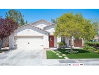 Charming single-story home with a well-manicured lawn and a two car garage at 5000 Charlo Dr, Las Vegas, NV 89131