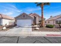 Charming single-story home featuring desert landscaping, a two-car garage, and a welcoming front entrance at 5244 Velazco Ln, Las Vegas, NV 89130