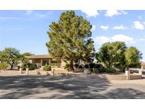 Spacious front yard with mature trees and a well-maintained lawn at 5518 Avenida Vaquero, Las Vegas, NV 89108