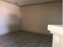 This living room offers a spacious area and attractive wood-look floors for a modern design at 5525 W Flamingo Rd # 2037, Las Vegas, NV 89103
