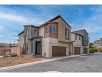 Modern two-story home with a neutral color palette and a two-car garage on a sunny day at 6148 Juniper Grove St, Las Vegas, NV 89148