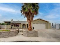 Charming single-story home with a lush palm tree, a two-car garage, and a well-kept front yard at 804 Cherry Dr, Henderson, NV 89002