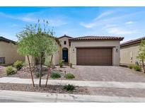 Charming single-story home featuring a tile roof, desert landscaping, and a two-car garage at 851 Klamath Springs St, Henderson, NV 89011