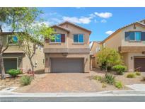 Two-story home featuring a two-car garage and desert landscaping at 9636 Salford Isle St, Las Vegas, NV 89123