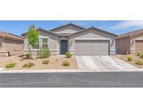 Charming single-story home featuring a two-car garage and low maintenance desert landscaping at 456 Desoto Falls St, Indian Springs, NV 89018