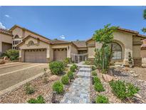Charming single-story home with landscaped front yard and tiled walkway to the gated entrance at 521 Dawn Cove Dr, Henderson, NV 89052