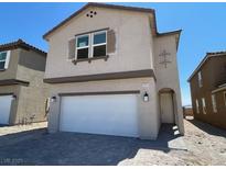 Charming two-story home featuring a large two-car garage and inviting architectural details at 9556 Hinson St, Las Vegas, NV 89139