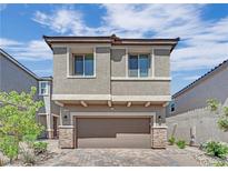 Charming two-story home featuring a paver driveway, attached two car garage and neutral exterior at 10038 W Meranto Ave, Las Vegas, NV 89178