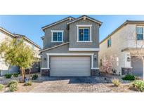 Charming two-story home with a brick driveway and a well-maintained front yard at 10042 Bismuth St, Las Vegas, NV 89183