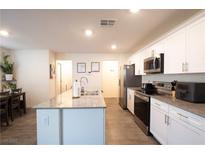 Bright kitchen with granite counters, stainless appliances, and a kitchen island at 2678 Weathered Copper Ave, North Las Vegas, NV 89086