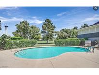 Refreshing community pool with lounge chairs and view of the golf course on a sunny day at 2831 Geary Pl # 2918, Las Vegas, NV 89109
