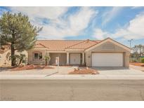 Charming single-story home showcasing a well-manicured front yard and a two-car garage under a sunny sky at 3116 Richland Dr, Las Vegas, NV 89134