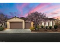 Charming single-story home featuring a well-manicured lawn and a three-car garage at 5265 Lucca Ln, Pahrump, NV 89061