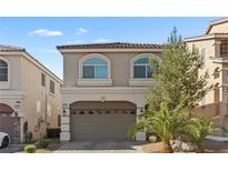 Charming two-story home with a well-maintained front yard and a two car garage and beautiful plants and palm trees at 5419 Holding Ave, Las Vegas, NV 89139