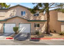 Charming townhome featuring attached garages, manicured landscaping, and a welcoming facade at 5612 Coder Ct, Las Vegas, NV 89118