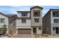 Charming two-story home featuring a balcony, a two-car garage, and meticulous landscaping, adding curb appeal to this lovely residence at 7482 Lodano Ave, Las Vegas, NV 89113