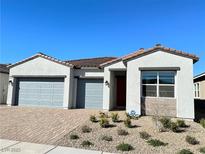Charming single-story home featuring a three-car garage and desert landscaping at 80 Brixton Ave, Henderson, NV 89011