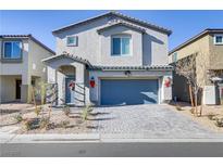Charming two-story home with a blue front door, manicured landscaping, and a two-car garage at 8351 Gold River Ct, Las Vegas, NV 89113