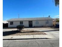 Charming single-story home featuring neutral paint, mature landscaping, and a spacious front yard at 893 Laramore Dr, Las Vegas, NV 89119