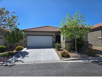 Charming single-story home featuring a tile roof, stone accents, and a well-maintained front yard at 9463 Jumping Frog Ct, Las Vegas, NV 89147