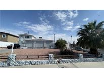 Charming two-story home featuring a desert landscape and palm tree at 1740 Capistrano Ave, Las Vegas, NV 89169
