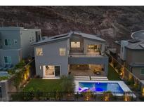 Modern two-story home featuring a pool, covered patio, and balcony with stunning views of the surrounding landscape at 298 Watteau Ct, Henderson, NV 89012
