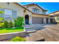 Charming two-story home with a three-car garage and beautifully landscaped front yard at 3360 Lochside Dr, Henderson, NV 89044