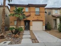 Charming two-story home with a desert landscape, concrete path, and warm-toned stucco exterior at 520 Shire Hall St, Las Vegas, NV 89178