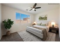 Bright bedroom featuring a large window, ceiling fan, and neutral décor for a relaxing ambiance at 909 Trinity Pond Cir, Henderson, NV 89002