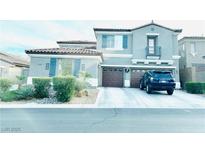 Charming two-story home features a two-car garage, and blue shutters, creating a welcoming curb appeal at 10013 Scenic Walk Ave, Las Vegas, NV 89149