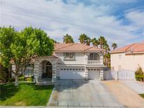 Charming two-story home with a well-manicured lawn, arched entryway and spacious three car garage at 1430 October Oak Ave, Las Vegas, NV 89123