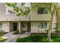 Inviting two-story townhouse with a well-maintained lawn and garden, plus a decorative wreath on the front door at 2681 Ruthe Duarte Ave, Las Vegas, NV 89121