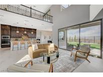 Bright, open-concept living space with high ceilings and seamless indoor-outdoor flow to the backyard at 350 Gandara St, Las Vegas, NV 89138