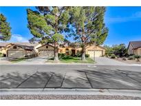Charming single-story home featuring mature trees, a well-maintained lawn, and a two-car garage at 5541 Port Barrington Way, Las Vegas, NV 89130