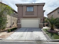 Charming two-story home featuring a spacious two car garage and well-maintained landscaping at 6495 Chettle House Ln, Las Vegas, NV 89122