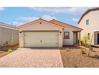 Charming single-story home with a two-car garage, landscaped with a brick driveway and desert plants at 6760 Violet Cascade Ave, Las Vegas, NV 89156