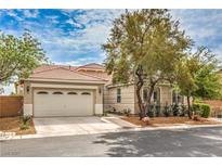 Charming single-story home featuring a two-car garage, desert landscaping, and a red tile roof at 7716 Twin Tails St, Las Vegas, NV 89149