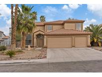 Inviting home with desert landscaping, tile roof, and an attached two-car garage at 7808 Brook Valley Dr, Las Vegas, NV 89123