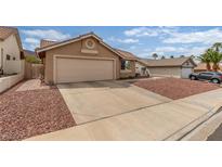Inviting single-story home featuring a two-car garage and low-maintenance desert landscaping in the front yard at 805 Blue Springs Dr, Henderson, NV 89002