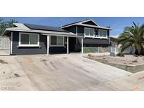 Charming home with solar panels, a spacious driveway, and a well-maintained yard at 904 Rockaway St, Las Vegas, NV 89145