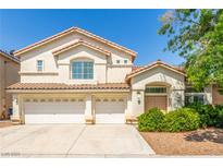 Charming two-story home with a three-car garage and well-manicured landscaping in a suburban neighborhood at 9339 Bondeno St, Las Vegas, NV 89123