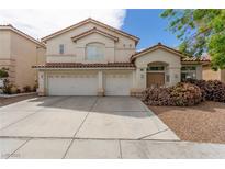 Charming two-story home with a spacious driveway and a well-maintained front yard at 9339 Bondeno St, Las Vegas, NV 89123