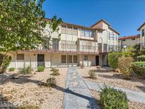 Spacious multi-story condo complex with a walkway and low maintenance landscaping at 2080 Karen Ave # 34, Las Vegas, NV 89169