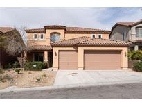 Two-story home featuring a tile roof, two-car garage, and desert landscaping at 2532 Bechamel Pl, Henderson, NV 89044
