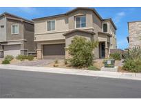 Charming two-story home featuring neutral stucco, a paved driveway and lush landscaping at 272 Mount Steele Ave, Henderson, NV 89015