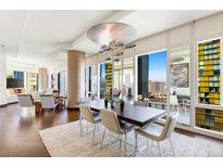 Elegant dining room with modern chandelier, a large wood table, and city views at 3750 Las Vegas Blvd # 2407, Las Vegas, NV 89158
